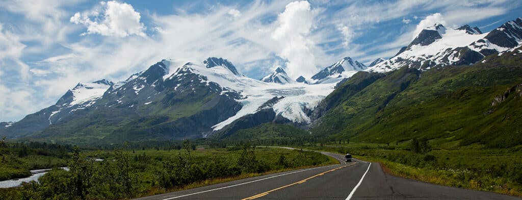 Bus on the highway with a glacier in the background