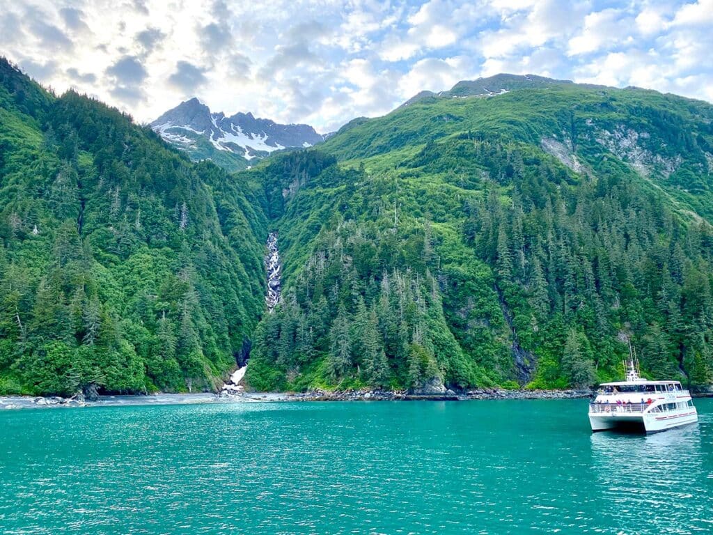 Glacier Spirit boat next to waterfall