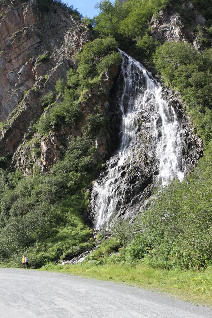 Two folks looking at Horsetail water falls from the road