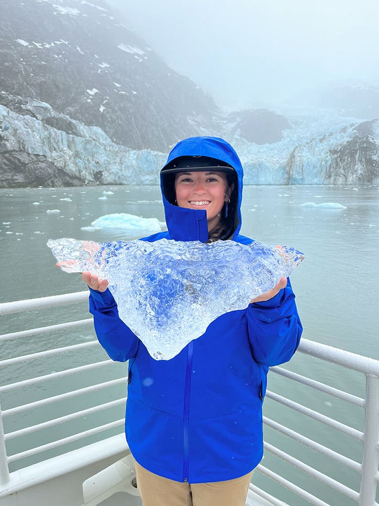 Kira holding large piece of ice